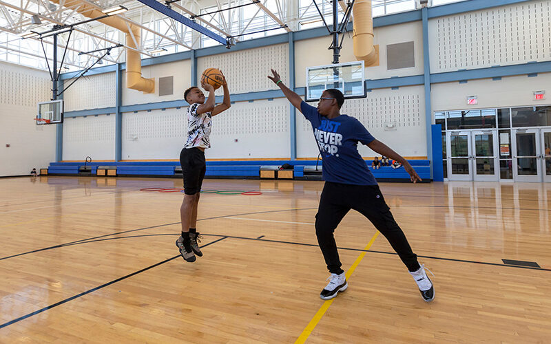 two boys playing basketball