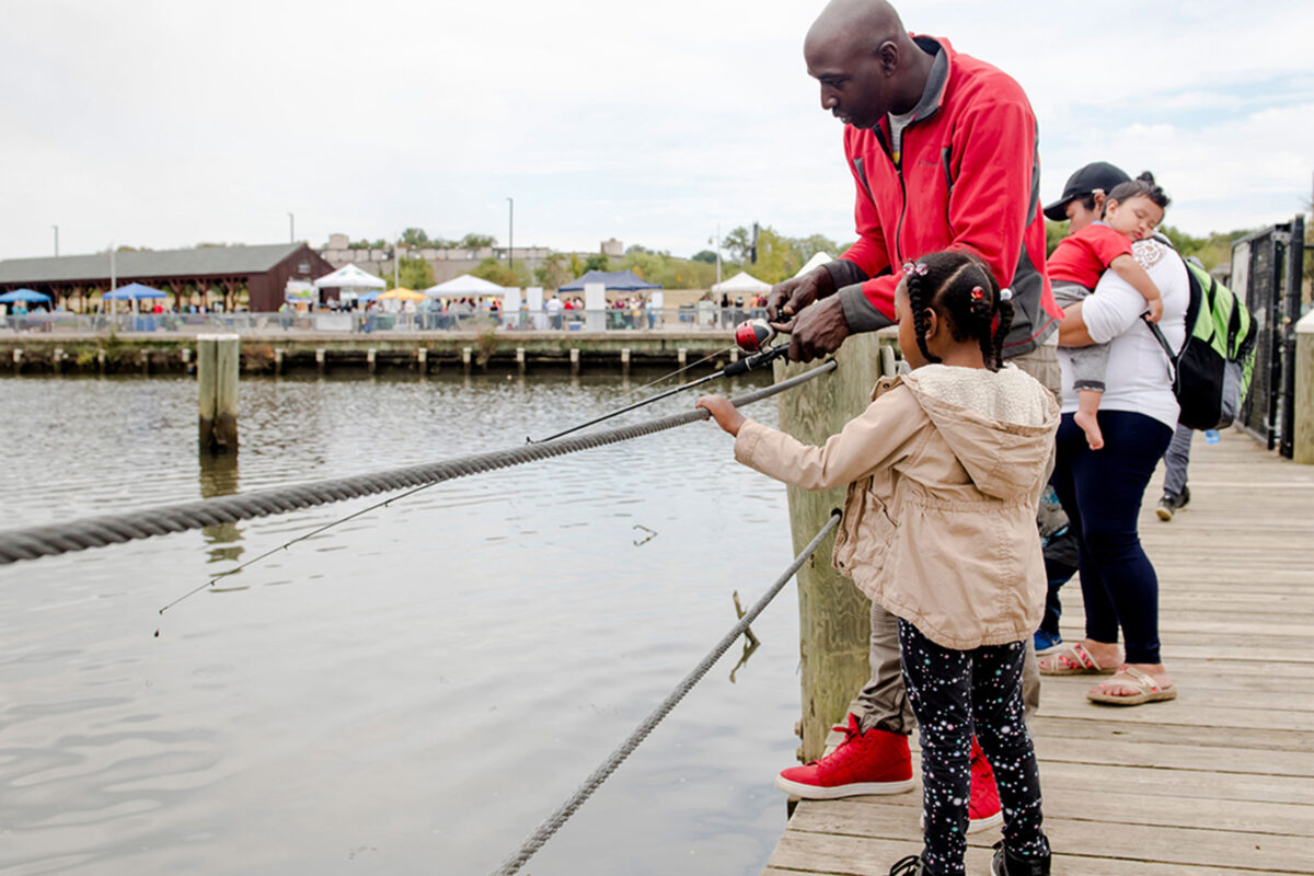 A father and a daughter fish together