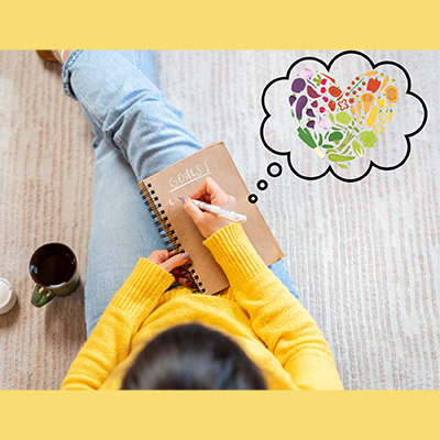 Girl setting goals in notebook