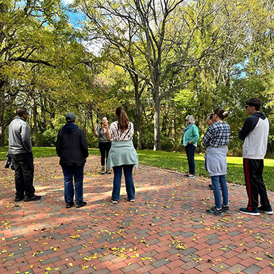 People listening to a lecture outdoors