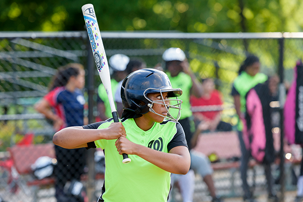 A girl up to bat at a softball game