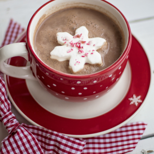 A red and white teacup filled with hot chocolate