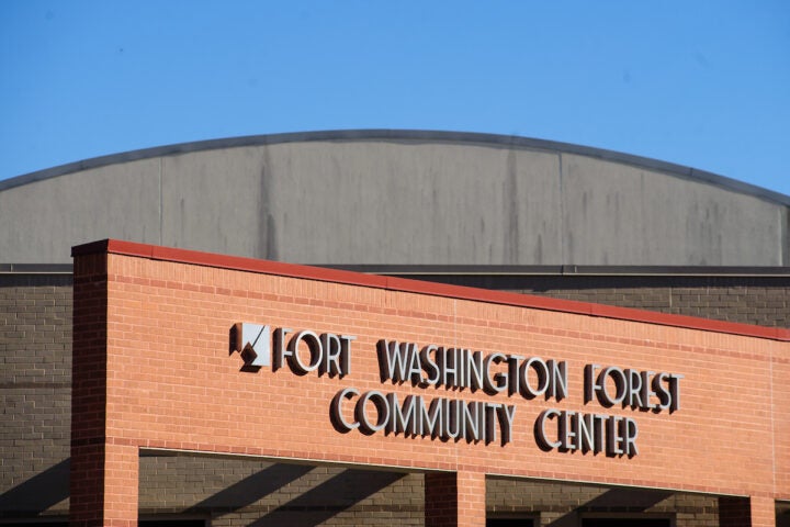 Close-up view of the words FORT WASHINGTON FOREST COMMUNITY CENTER on the red brick facade of a building.