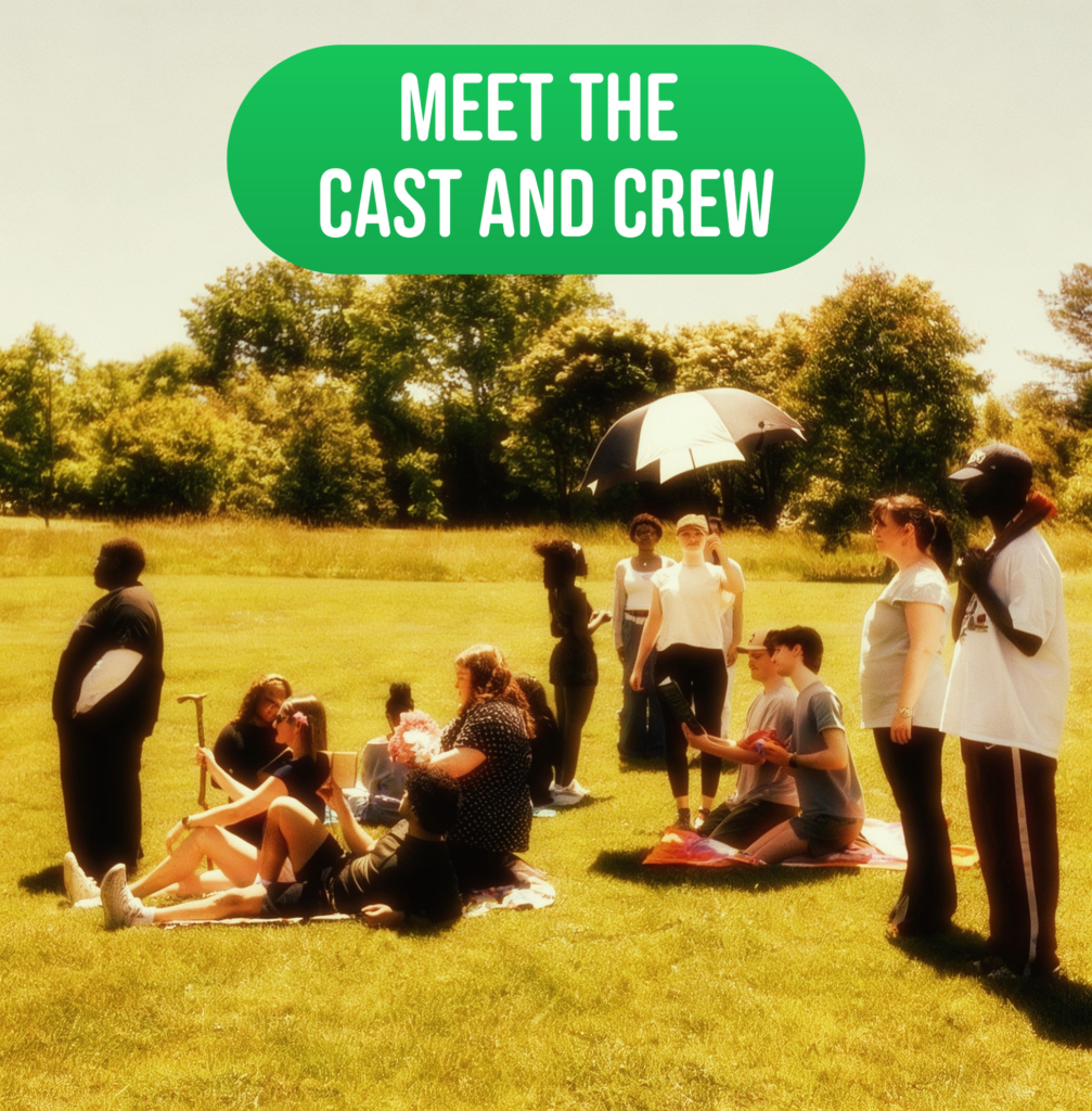 Group of people sitting and standing in sunny field under umbrella, “Meet the Cast and Crew” banner above.